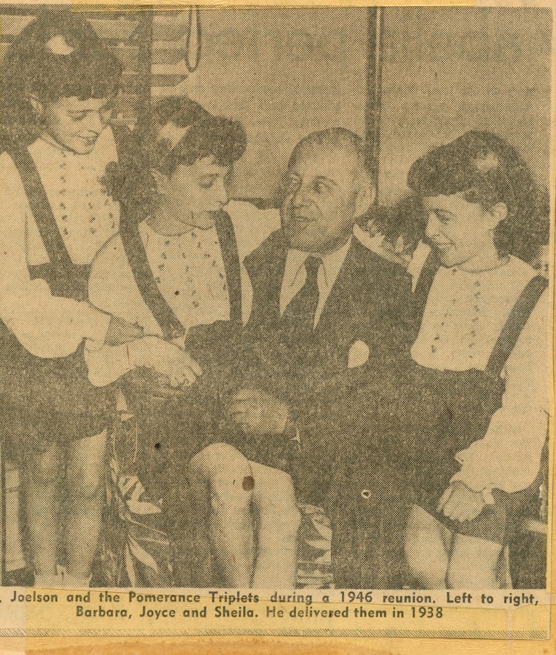 Dr. Joelson and the Pomerance Triplets during a 1946 reunion