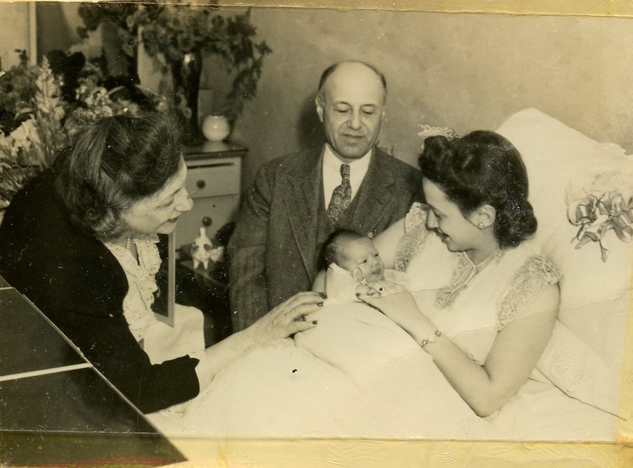 Hospital photograph of Dr. Morris Joelson with Mrs. Pomerance holding one of the triplets