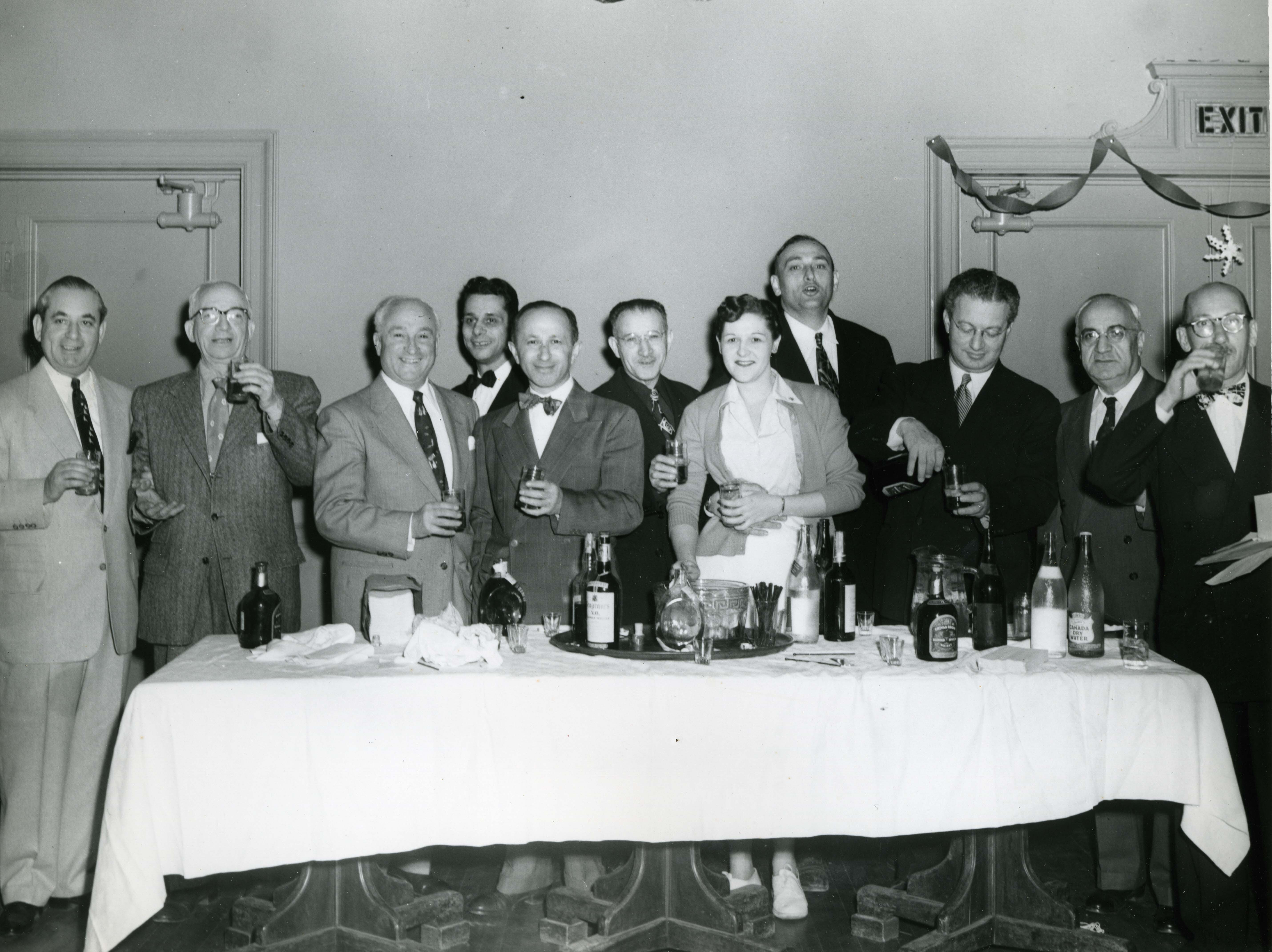 Unidentified Passaic men and a woman making a toast?